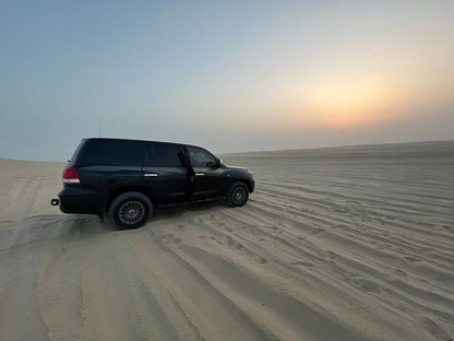 Doha : utilisation d'une journée dans un camp dans le désert, safari en option, sandboard et balade à dos de chameau